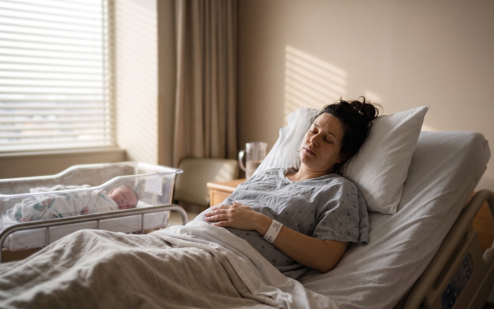 New mother in postpartum recovery reflecting on a case involving medical negligence in childbirth