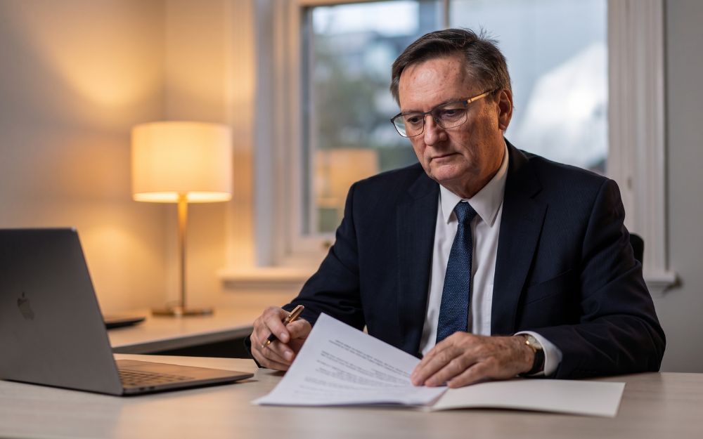 Lawyer carefully reviewing a case at his desk, illustrating legal rights around birth trauma claims